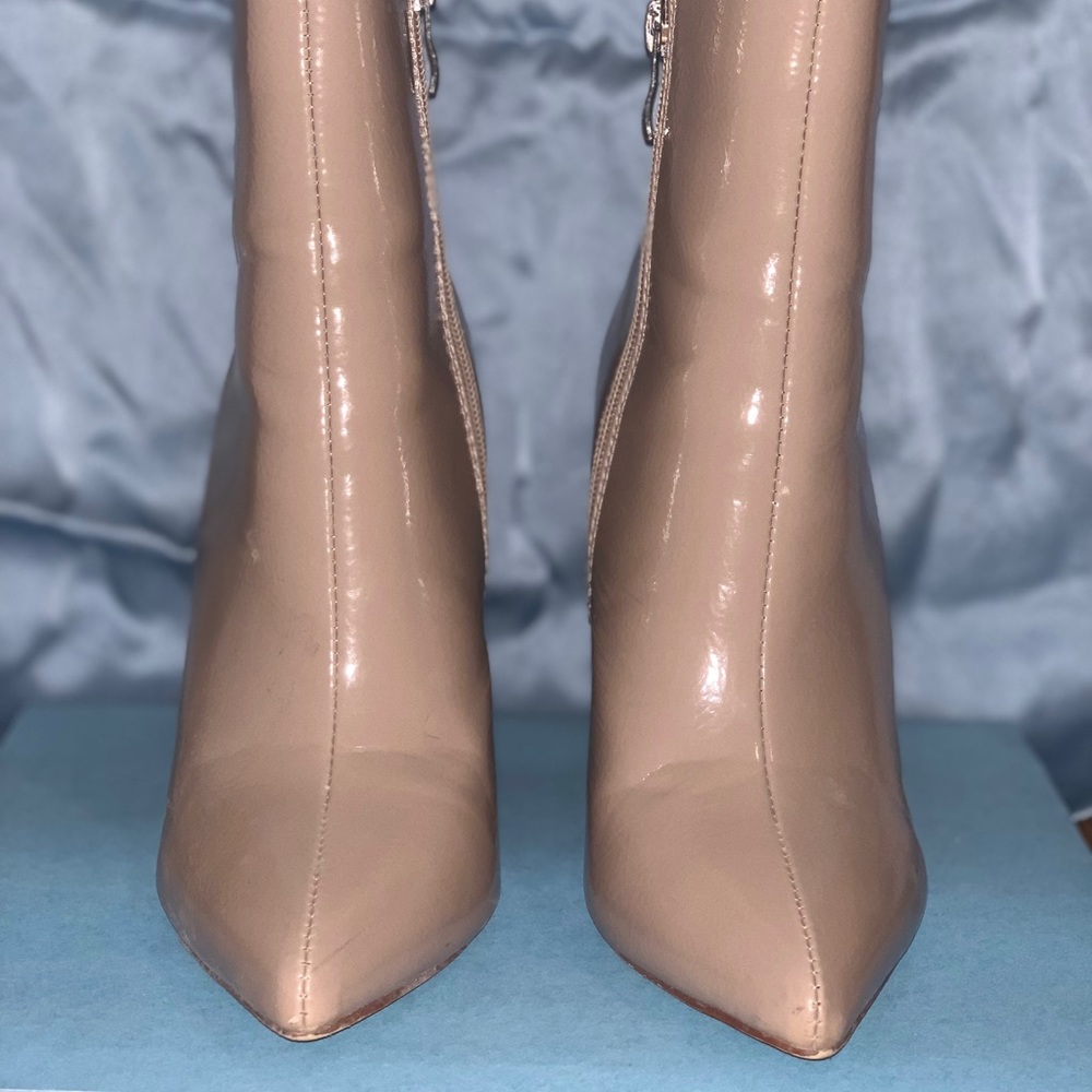 Nude wooden block patent leather boots.